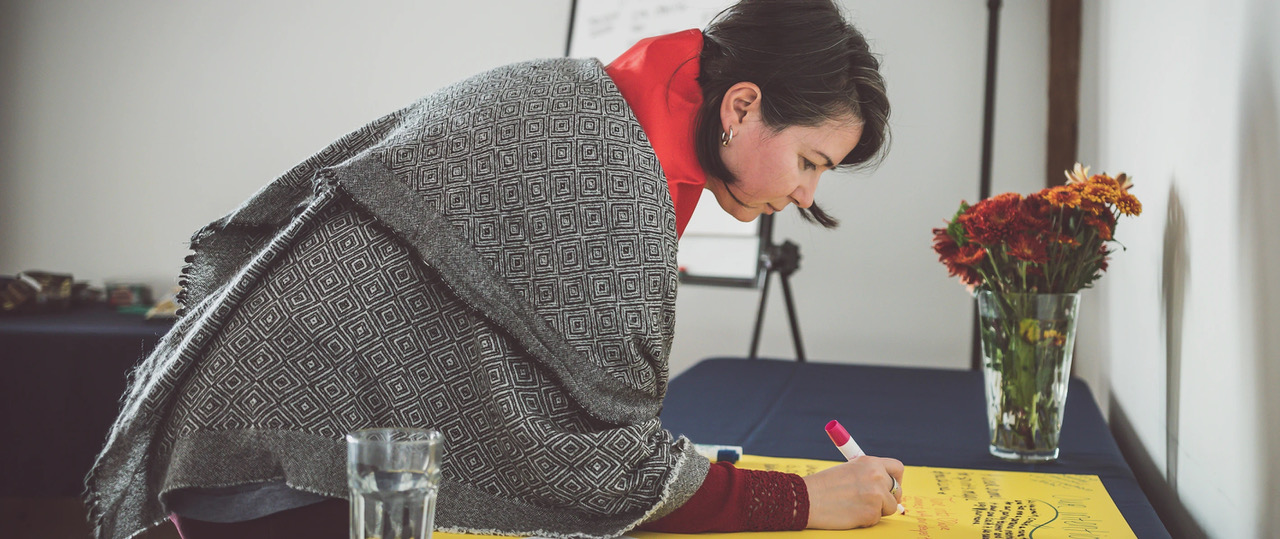 Mela writing during a facilitated session